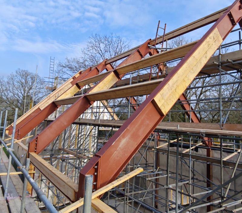 Built timber frame on site, scaffold up, structural members in place